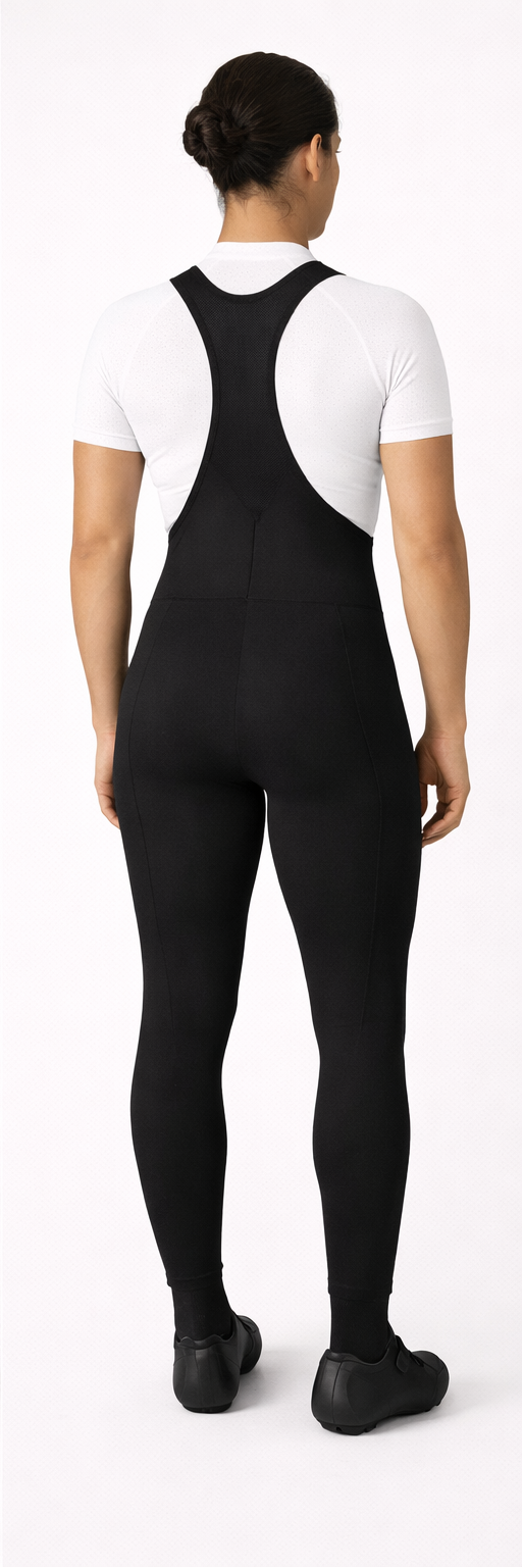 Black bib overalls worn by a person on a white background