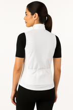 Woman wearing a white vest over a black shirt on a white background